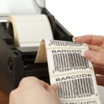 "Barcode label printer with the labels ribbon, close-up on white background. All about bar-codes in my lightbox:"